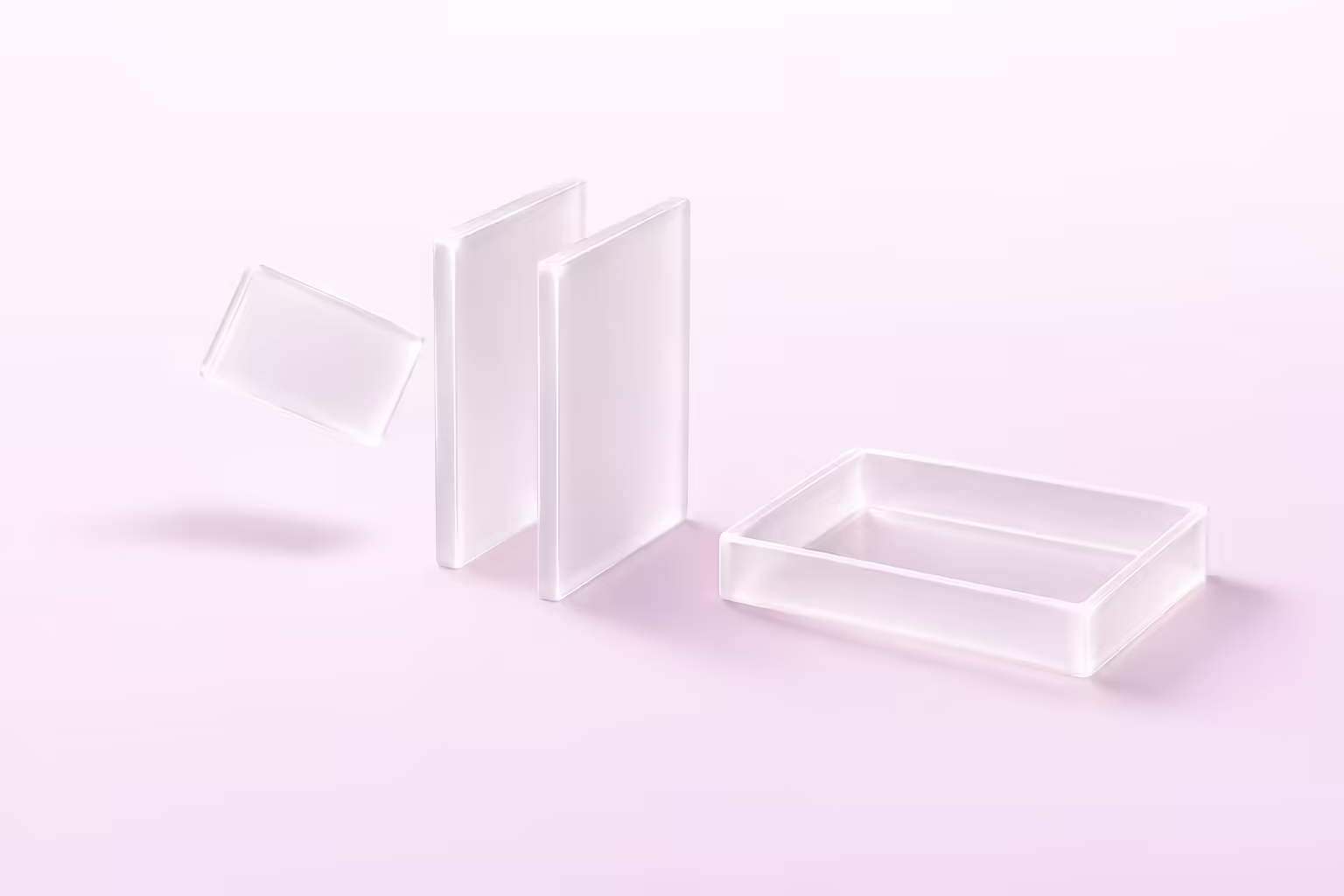 A small frosted glass tile passing through a narrow channel formed by two upright glass slabs toward a shallow open glass tray