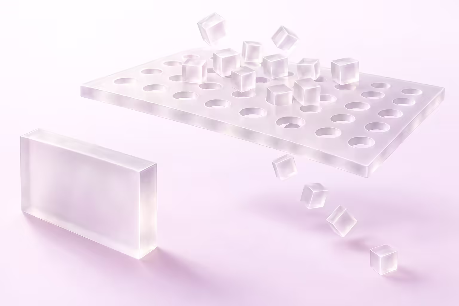A perforated frosted glass plate with translucent cubes resting on top and falling through its holes, beside a solid glass block